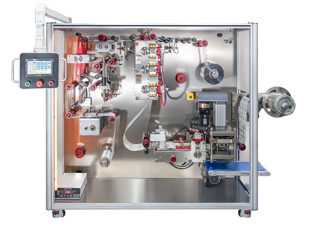 KP-4 snap-open card packaging machine with film rolls, registration mechanism and operator control panel